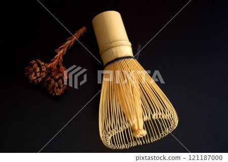 Tea whisk on a black background 121187000