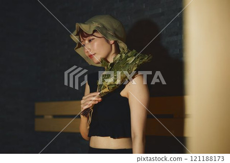 A woman using a vihta in a sauna. Photo courtesy of Shiratama no Yu Izumikei A woman using a vihta in a sauna. Photo courtesy of Shiratama no Yu Izumikei 121188173
