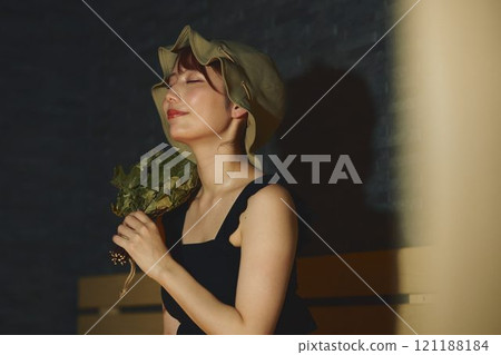 A woman using a vihta in a sauna. Photo courtesy of Shiratama no Yu Izumikei 121188184