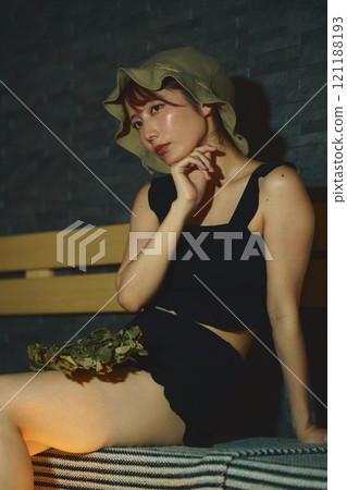 A woman using a vihta in a sauna. Photo courtesy of Shiratama no Yu Izumikei 121188193
