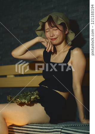 A woman using a vihta in a sauna. Photo courtesy of Shiratama no Yu Izumikei 121188194