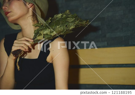 A woman using a vihta in a sauna. Photo courtesy of Shiratama no Yu Izumikei 121188195
