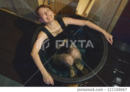 A woman bathing in a cold bath. Photo courtesy of Shiratama no Yu Izumi Kei 121188667