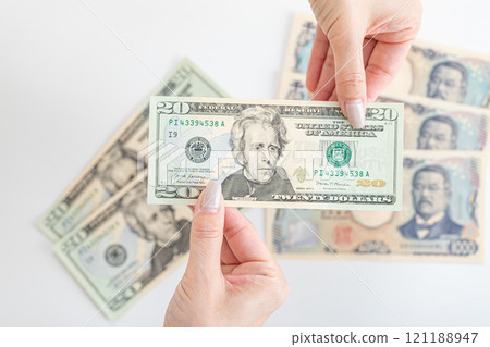 Dollar bills being handed over 121188947