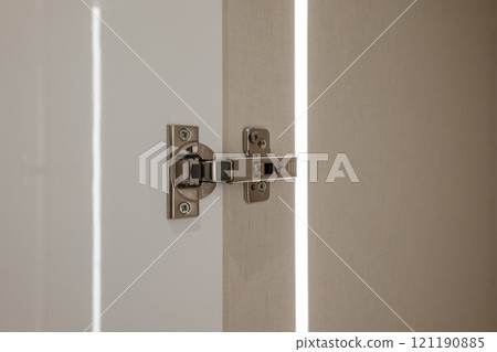 This is a closeup view of a door hinge that features a modern and innovative design aesthetic 121190885