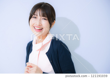 Image of a nurse happy about a successful job change: Close-up of a smiling general nurse looking at the camera 121191039