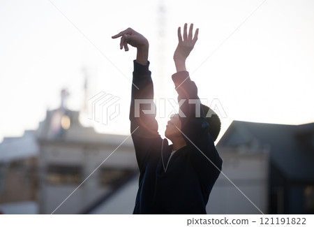 A boy taking a basketball jump shot. Image of sports and club activities. A boy taking a basketball jump shot. Image of sports and club activities. 121191822