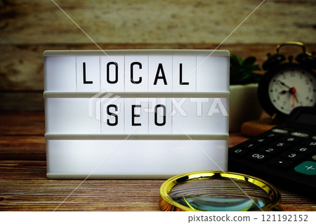 LOCAL SEO letterboard text on LED Lightbox on wooden background, business and technology concept background LOCAL SEO letterboard text on LED Lightbox on wooden background, business and technology concept background 121192152