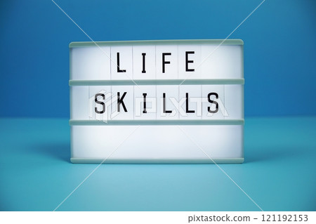 Life Skills letterboard text on LED Lightbox on blue background 121192153