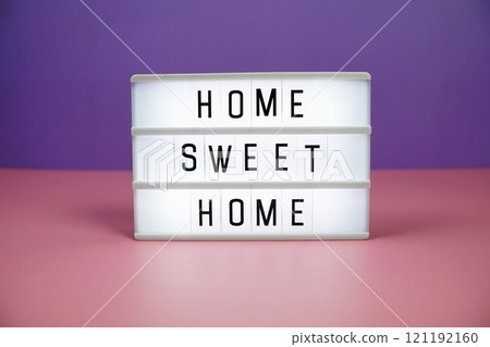 Home Sweet Home letterboard text on LED Lightbox on pink and purple background 121192160