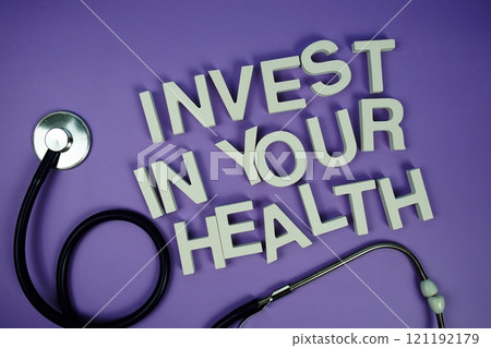 Invest in your health alphabet letters and stethoscope on purple background, Healthcare concept Invest in your health alphabet letters and stethoscope on purple background, Healthcare concept 121192179