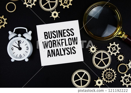 Business Workflow Analysis (BWA) text message on sticky note with magnifying glass and alarm clock on black background 121192222