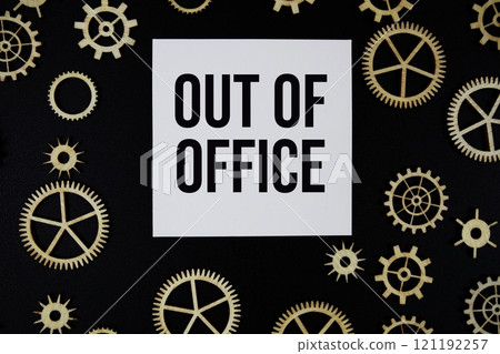 Out of Office text on paper and gear on black background 121192257