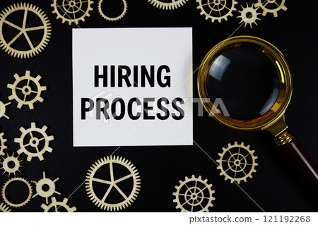 Hiring Process text with magnifying glass on black background Hiring Process text with magnifying glass on black background 121192268
