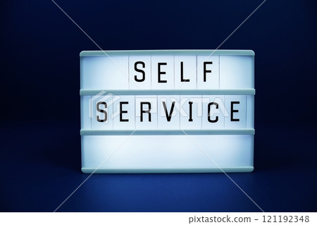 Self Service letterboard text on LED Lightbox on blue background Self Service letterboard text on LED Lightbox on blue background 121192348