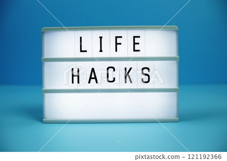 Life Hacks letterboard text on LED Lightbox on blue background Life Hacks letterboard text on LED Lightbox on blue background 121192366