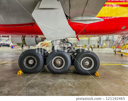 Aircraft Landing Gear Close-Up in Maintenance Hangar with Six Wheels. High quality photo Aircraft Landing Gear Close-Up in Maintenance Hangar with Six Wheels. High quality photo 121192465