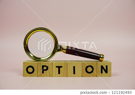 Option with wooden blocks alphabet letters and Magnifying glass on pink background 121192493