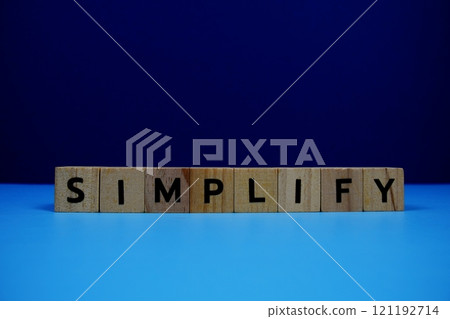 SimplifySimplify with wooden blocks alphabet letters on blue background 121192714