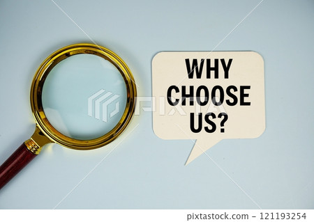 Why choose us? text on speech bubble with magnifying glass top view on blue background 121193254