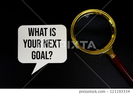 What is your next goal? text on speech bubble with magnifying glass top view on black background 121193334