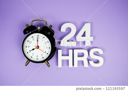 24 Hrs alphabet letters and alarm clock top view on purple background 121193597
