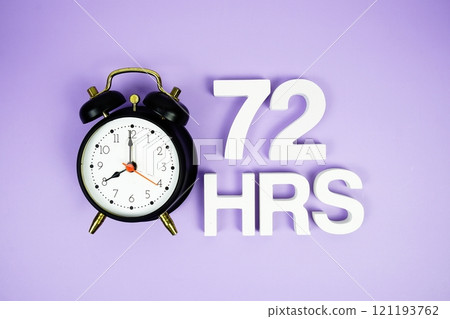 72 Hrs alphabet letters and alarm clock top view on purple background 72 Hrs alphabet letters and alarm clock top view on purple background 121193762