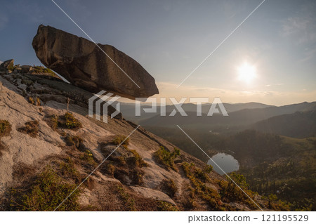cliff with large granite boulder hangs cliff with large granite boulder hangs 121195529
