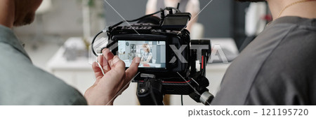 Website banner with unrecognizable director and operator assessing footage during shooting day Website banner with unrecognizable director and operator assessing footage during shooting day 121195720