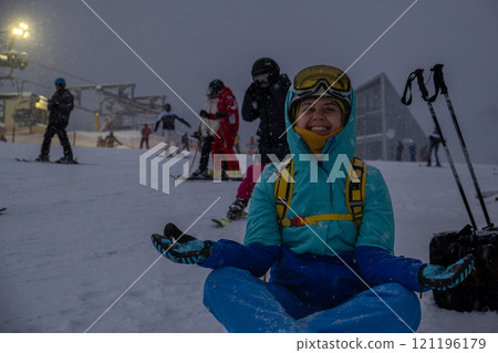 Skier Resting on Snowy Slope at Ski Resort 121196179