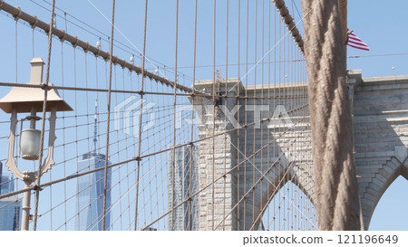 Brooklyn Bridge cables, Manhattan downtown. New York City skyline, financial district cityscape. Brooklyn Bridge cables, Manhattan downtown. New York City skyline, financial district cityscape. 121196649