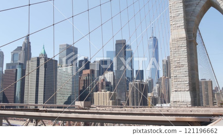 Brooklyn Bridge cables, Manhattan downtown. New York City skyline, financial district cityscape. Brooklyn Bridge cables, Manhattan downtown. New York City skyline, financial district cityscape. 121196662