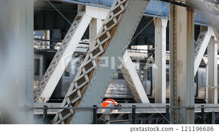 New York City Manhattan Bridge. Subway metro train from pedestrian path. Railway transport traffic. 121196686