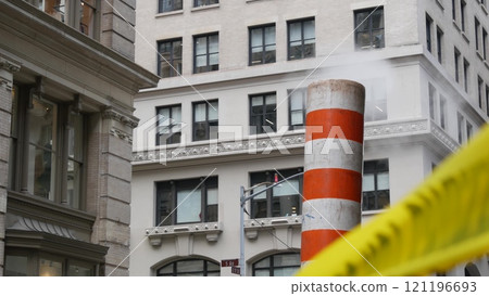 Steam vapor vented, New York City street steam system, orange vapour tube stack. Hot smoke from pipe Steam vapor vented, New York City street steam system, orange vapour tube stack. Hot smoke from pipe 121196693