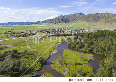 Aerial view of the road through the village, Sema river, mountains and valley in the Altai Mountains 121197255