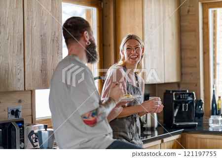 Mature couple having romantic moment in kitchen, preparing breakfast togeter. 121197755