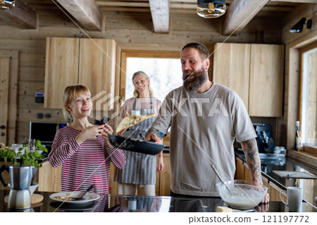 Family making pancakes, preparing christmas breakfast at morning. 121197772