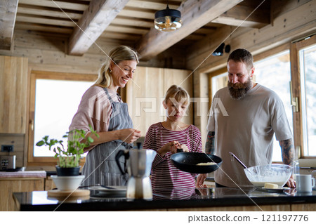 Family making pancakes, preparing christmas breakfast at morning. 121197776