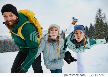 Family having fun in winter nature, playing in the snow. Family having fun in winter nature, playing in the snow. 121197785
