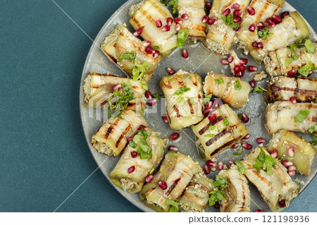 A plate of eggplant rolls. A plate of eggplant rolls. 121198936