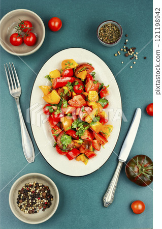 Fresh organic mixed salad with multi-colored tomatoes. Fresh organic mixed salad with multi-colored tomatoes. 121198942