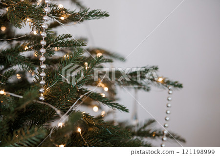 Elegant Christmas Tree Decorated with Silver Beads and Warm Lights 121198999