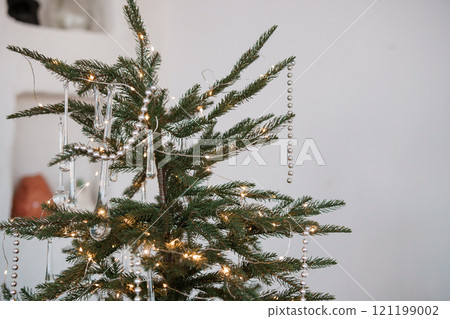 Elegant Christmas Tree Decorated with Strands of Beads and Warm Lights 121199002
