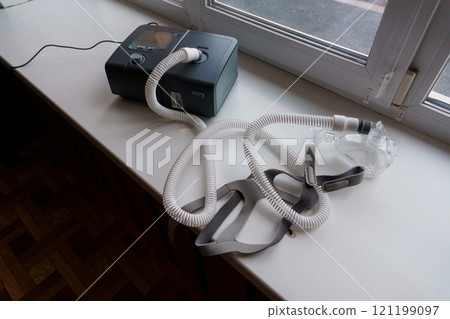 Home CPAP Machine on a Window Ledge Ready for Use 121199097