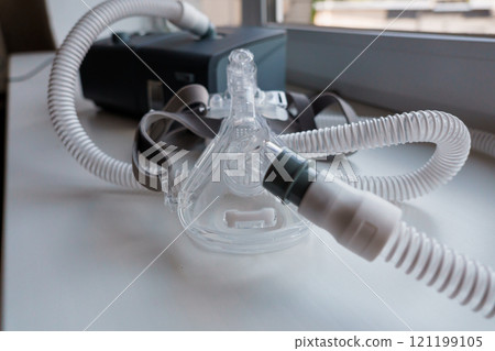 Advanced CPAP Machine with Attached Mask and Tubing on a Windowsill Advanced CPAP Machine with Attached Mask and Tubing on a Windowsill 121199105