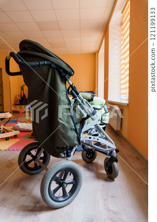 Modern Stroller in a Brightly Lit Children's Playroom Modern Stroller in a Brightly Lit Children's Playroom 121199133