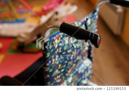 Colorful Floral Patterned Wheelchair in a Brightly Lit Room Colorful Floral Patterned Wheelchair in a Brightly Lit Room 121199153