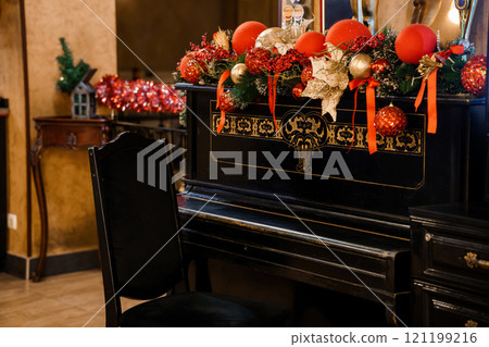 Elegant Christmas Decorated Piano in a Cozy Festive Room Elegant Christmas Decorated Piano in a Cozy Festive Room 121199216