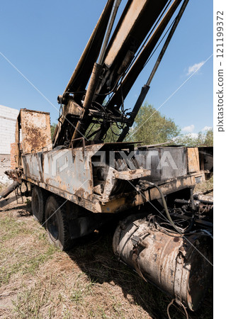 Abandoned Hydraulic Crane in an Overgrown Field 121199372