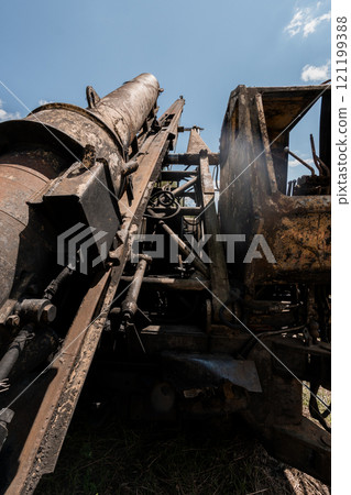 Rusty Excavation Machine Under a Bright Blue Sky 121199388